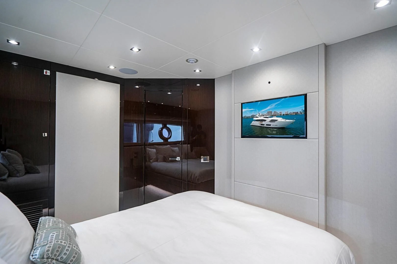 a hotel room with a bed and tv aboard QUANTUM Yacht for Sale