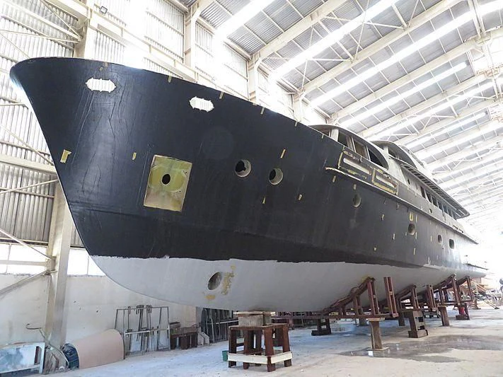 a large black airplane in a hangar aboard VOLARE Yacht for Sale