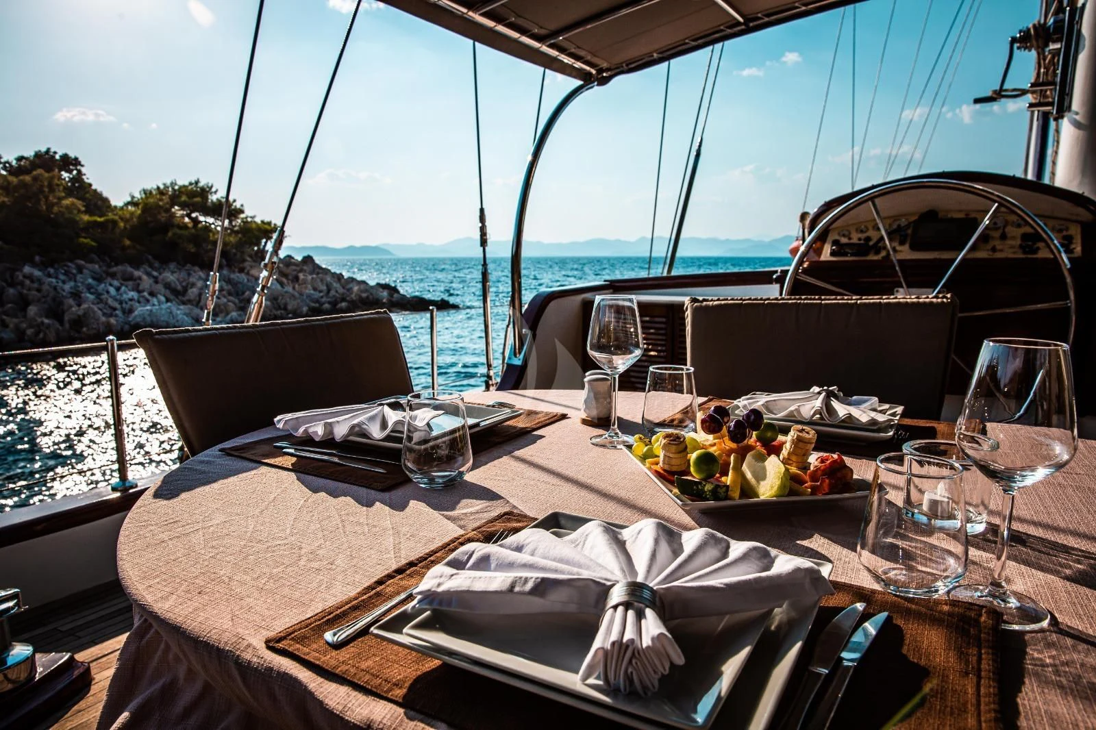a table with food and glasses on it aboard NAUTILUS Yacht for Sale