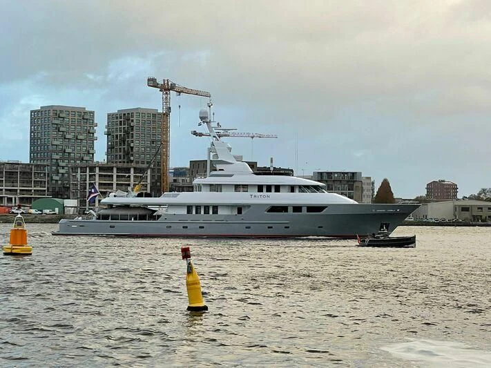 a large ship in the water aboard TRITON Yacht for Sale