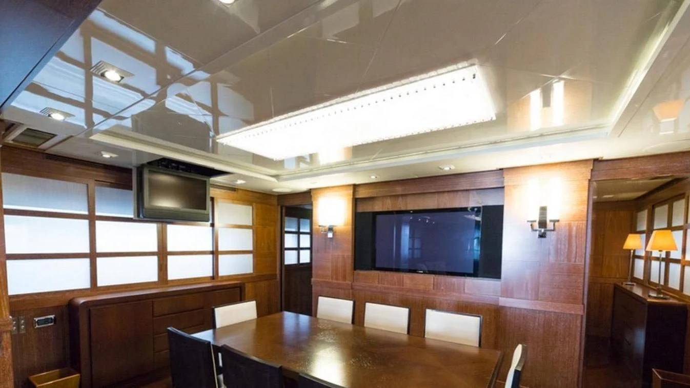a room with a table and chairs aboard TRITON Yacht for Sale