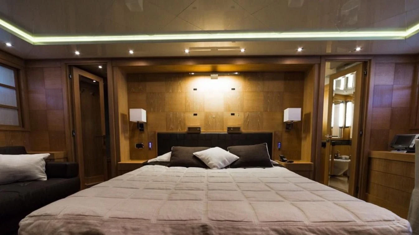 a large bed in a hotel room aboard TRITON Yacht for Sale