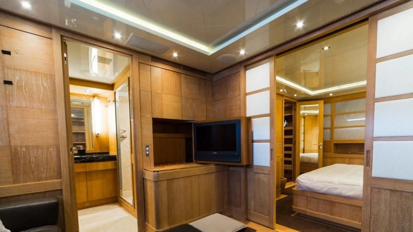 a room with a bed and a tv aboard TRITON Yacht for Sale