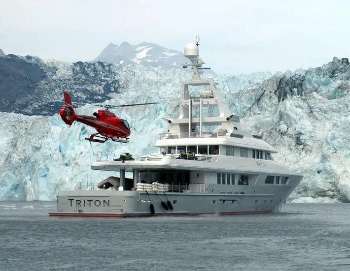 a helicopter flying over a boat aboard TRITON Yacht for Sale