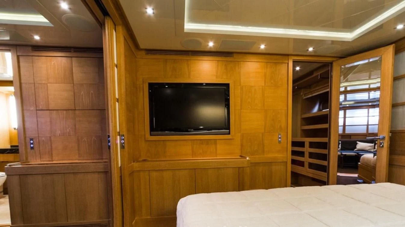 a room with a bed and a tv aboard TRITON Yacht for Sale