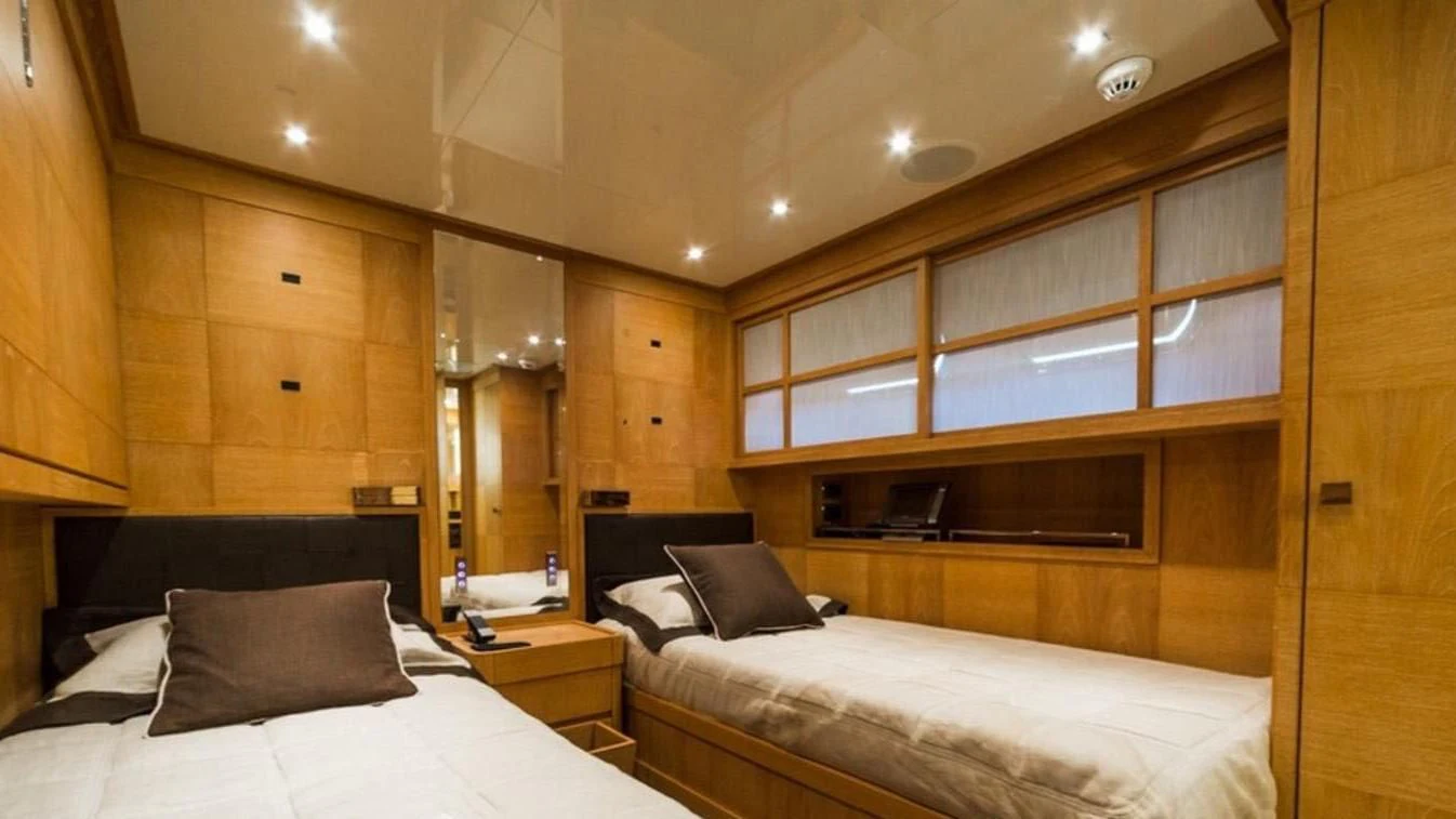 a room with a bed and a mirror aboard TRITON Yacht for Sale