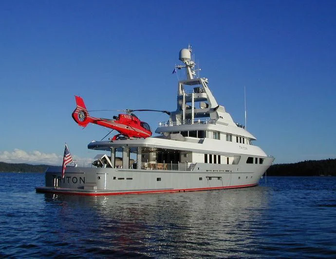 a boat with a helicopter on the top aboard TRITON Yacht for Sale