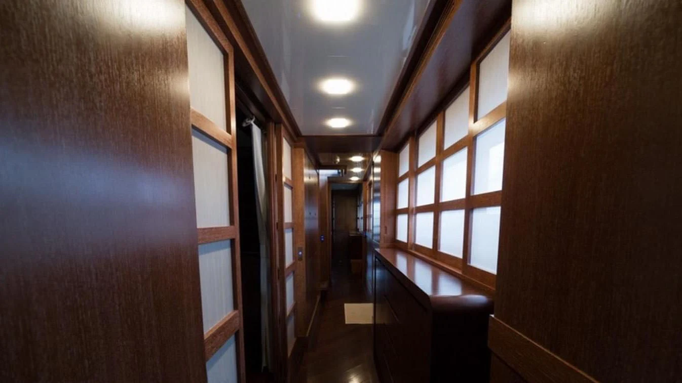 a hallway with windows aboard TRITON Yacht for Sale