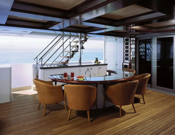 a table with chairs around it aboard TRITON Yacht for Sale
