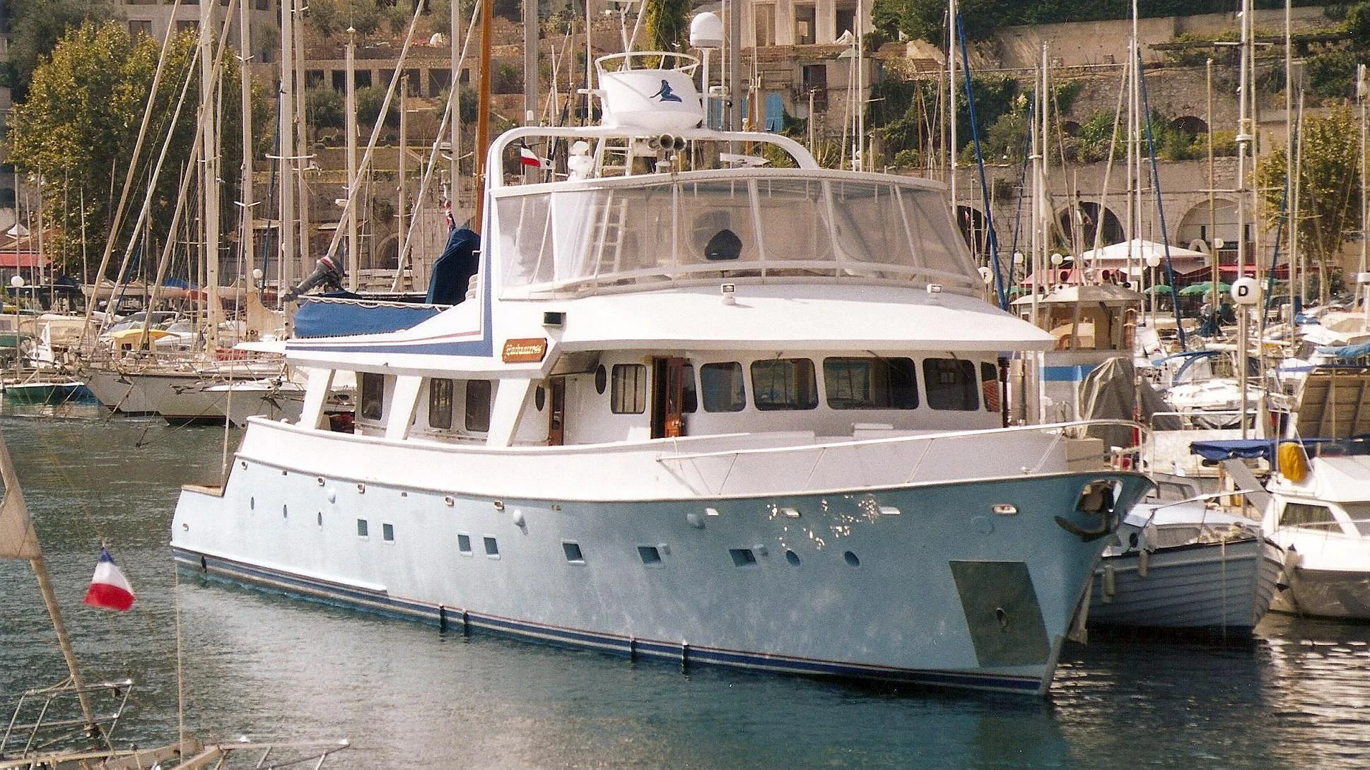 a boat docked in a harbor aboard ENCHANTRESS Yacht for Sale
