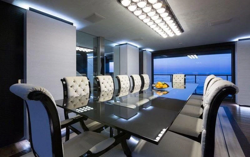 a room with chairs and a table aboard OCEAN PARADISE Yacht for Sale