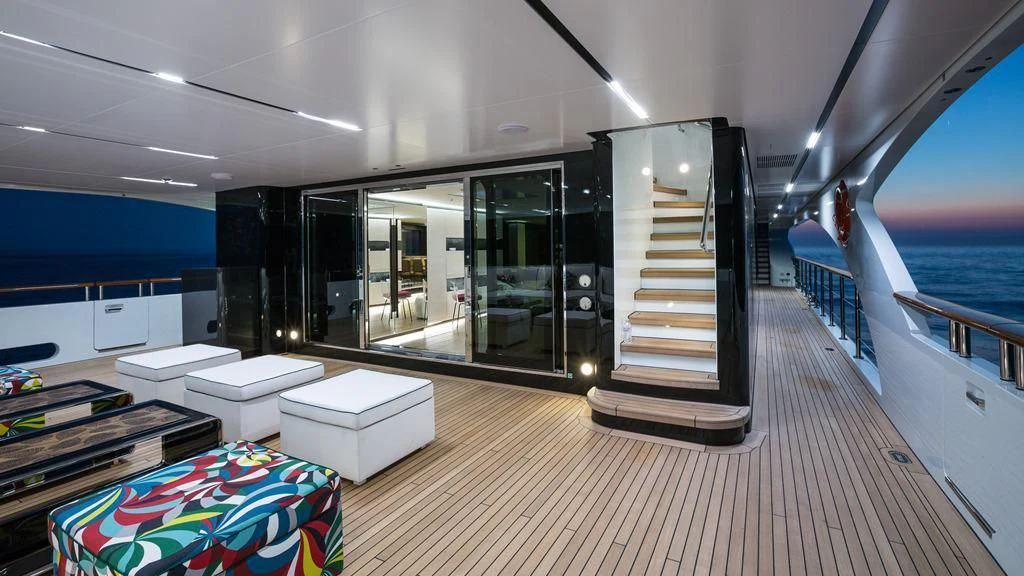 a room with a large glass door and a deck with a pool aboard OCEAN PARADISE Yacht for Sale
