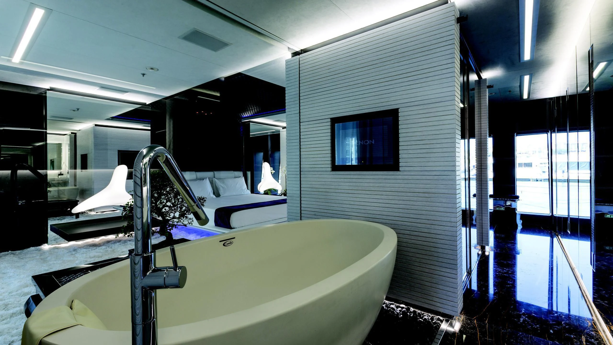 a room with a tub and a sink aboard OCEAN PARADISE Yacht for Sale
