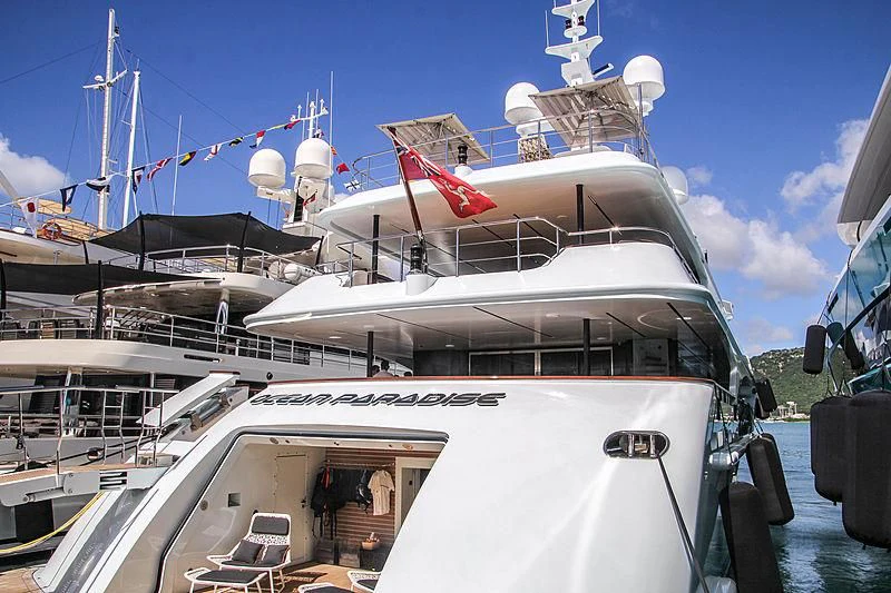 a large white boat with a red flag on the front aboard OCEAN PARADISE Yacht for Sale