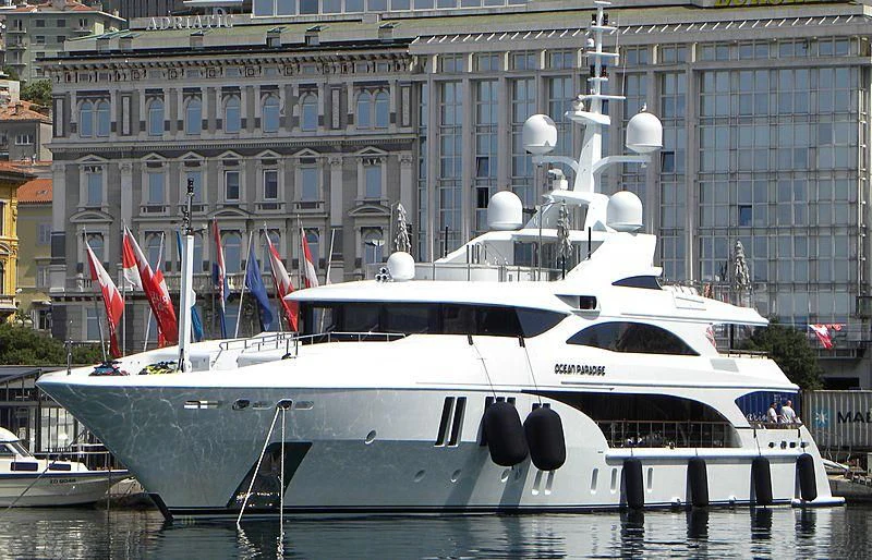 a boat docked in front of a building aboard OCEAN PARADISE Yacht for Sale