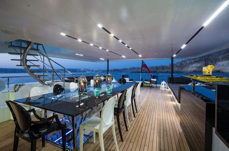 a room with a table and chairs aboard OCEAN PARADISE Yacht for Sale