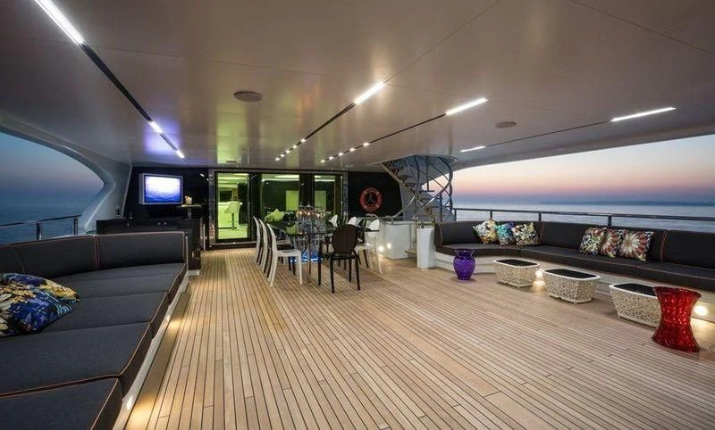 a living room with a wood floor aboard OCEAN PARADISE Yacht for Sale