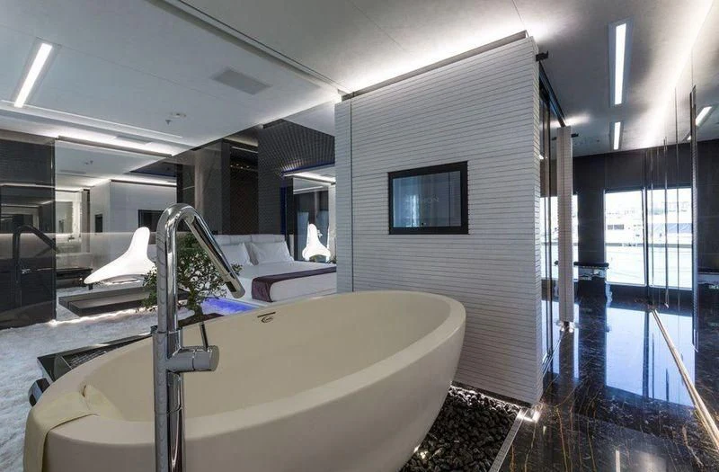 a bathroom with a tub sink and a mirror aboard OCEAN PARADISE Yacht for Sale
