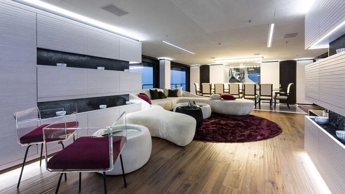 a room with a table chairs and a couch aboard OCEAN PARADISE Yacht for Sale