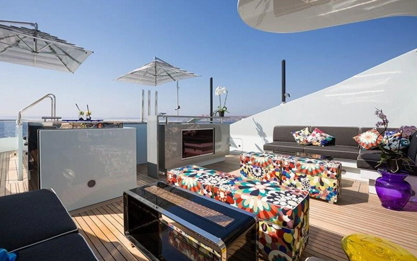 a room with a table and a tv aboard OCEAN PARADISE Yacht for Sale