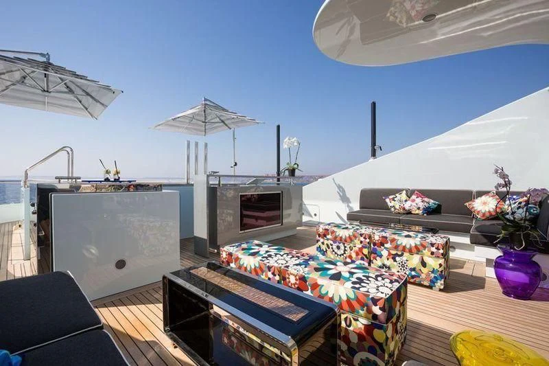 a room with a table and a tv aboard OCEAN PARADISE Yacht for Sale