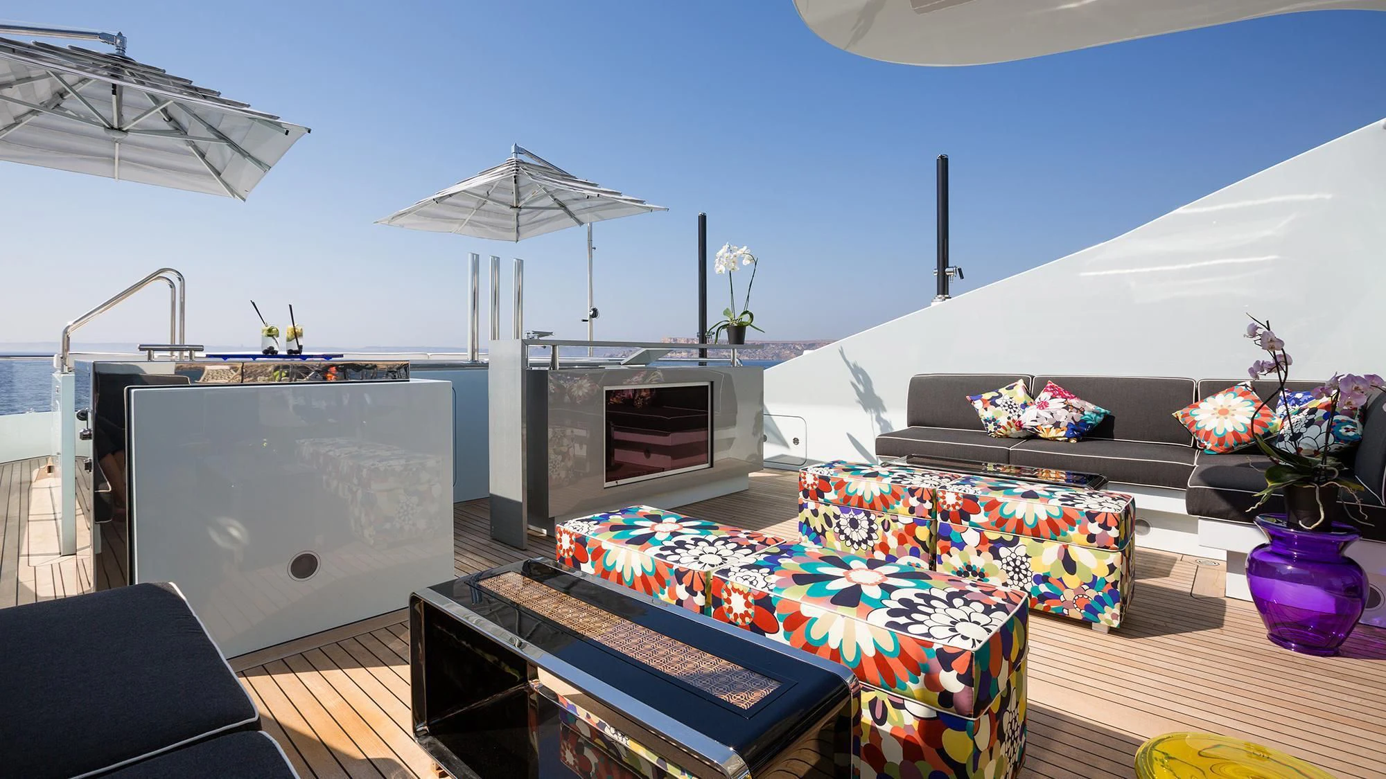 a room with a table and a tv aboard OCEAN PARADISE Yacht for Sale