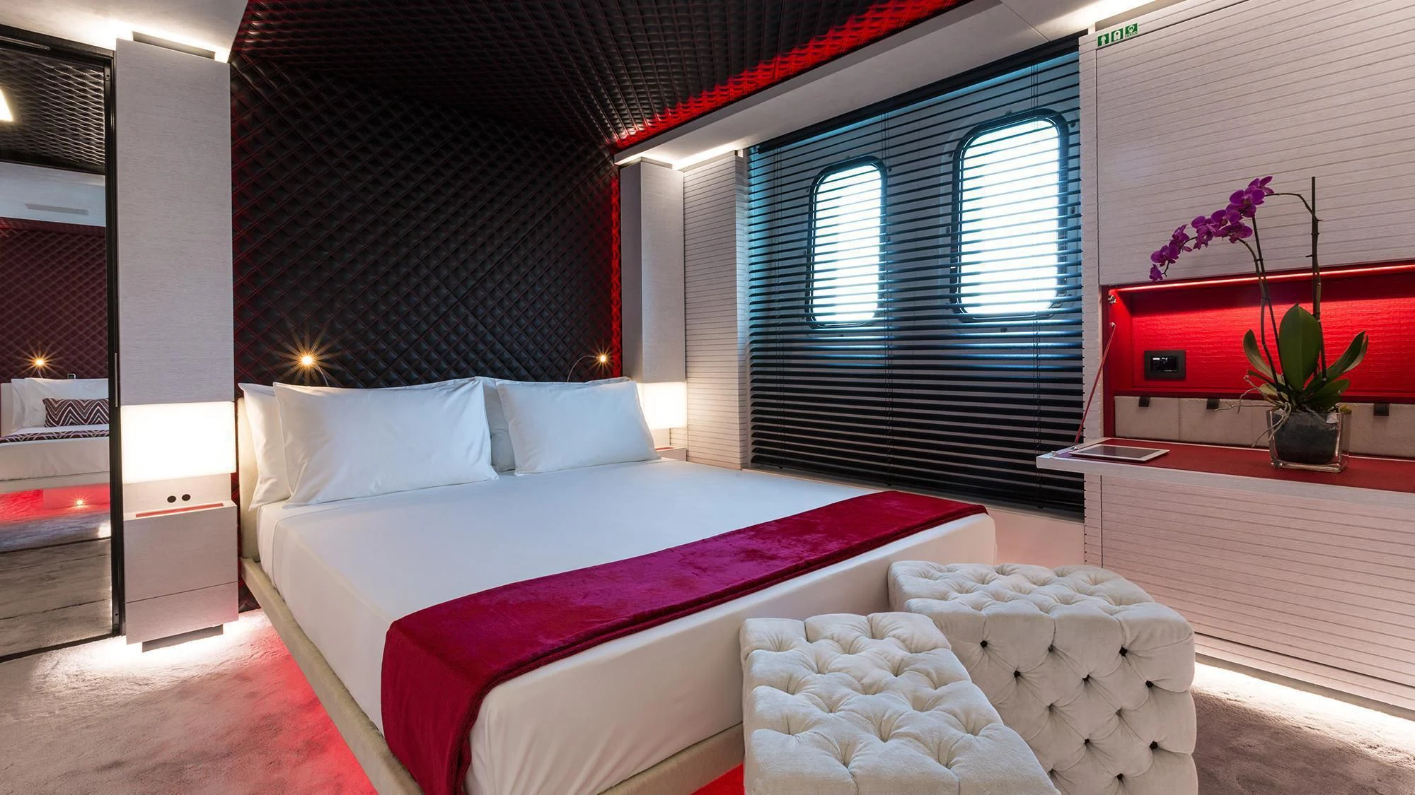 a bed with purple sheets aboard OCEAN PARADISE Yacht for Sale