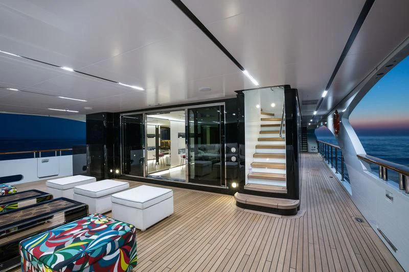 a room with a deck and a pool aboard OCEAN PARADISE Yacht for Sale