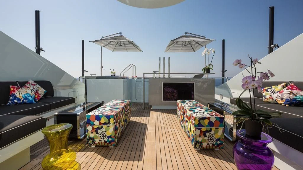 a room with a deck and a pool aboard OCEAN PARADISE Yacht for Sale