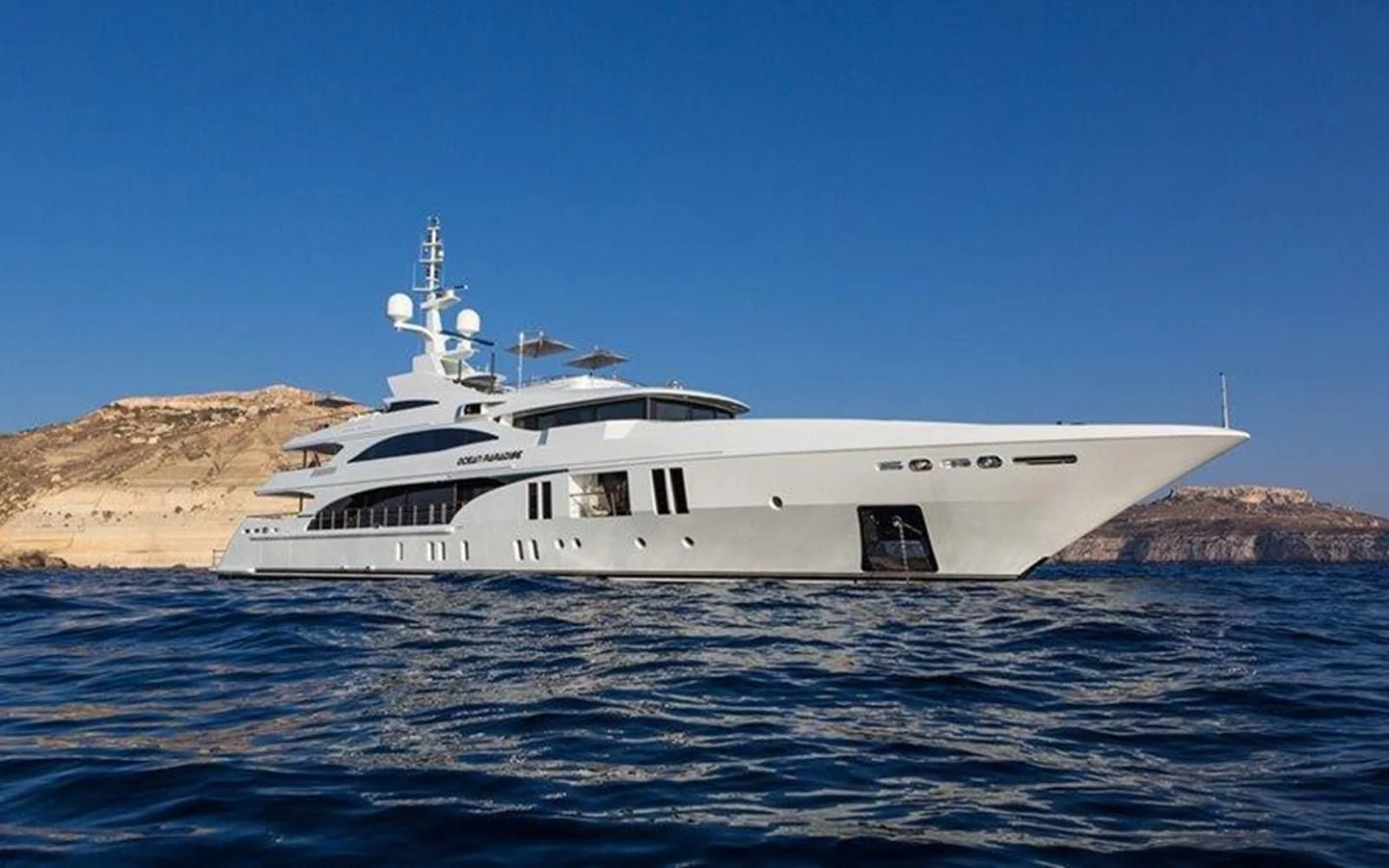 a white boat in the water aboard OCEAN PARADISE Yacht for Sale