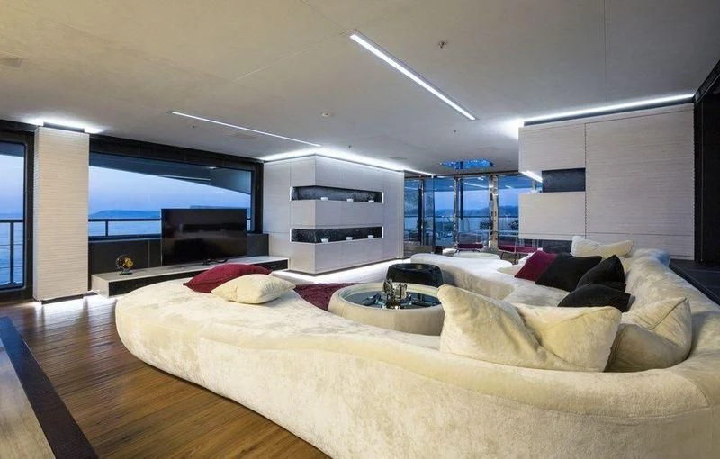 a large living room with a large window aboard OCEAN PARADISE Yacht for Sale