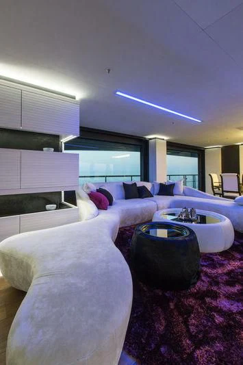 a bedroom with a bed and a table aboard OCEAN PARADISE Yacht for Sale