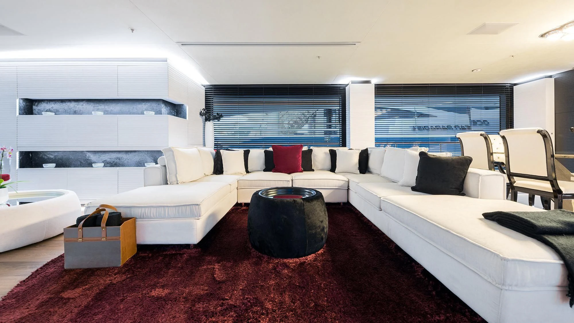 a living room with a large red rug and white couches aboard OCEAN PARADISE Yacht for Sale