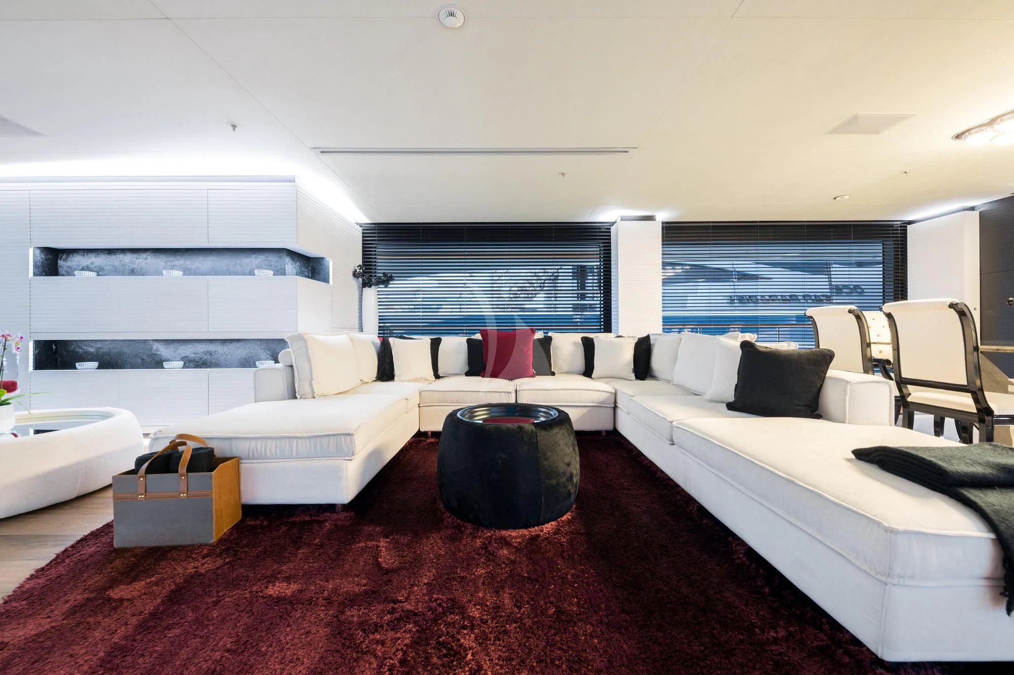 a large living room with white couches and a large window aboard OCEAN PARADISE Yacht for Sale