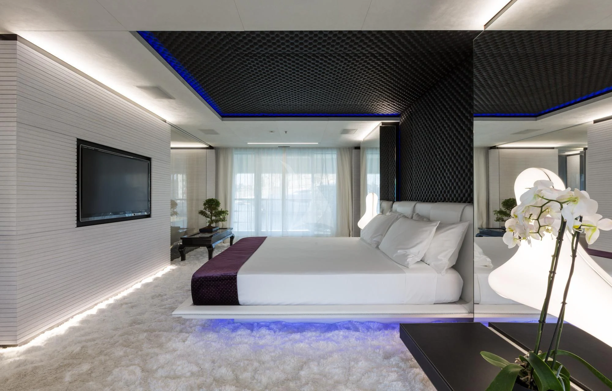 a bedroom with a bed and a television aboard OCEAN PARADISE Yacht for Sale