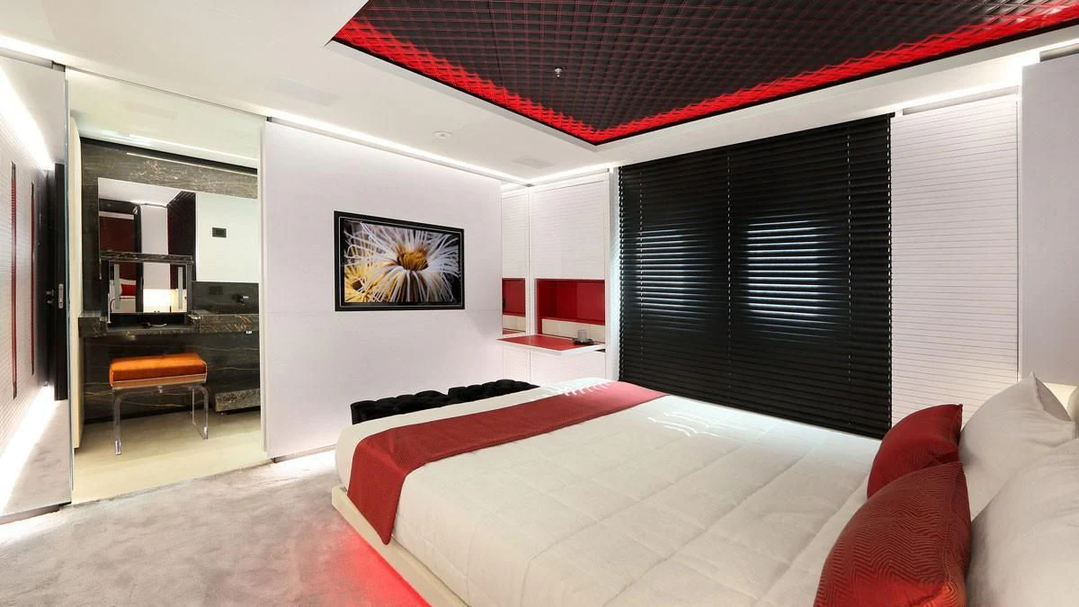 a room with a bed and a desk aboard OCEAN PARADISE Yacht for Sale