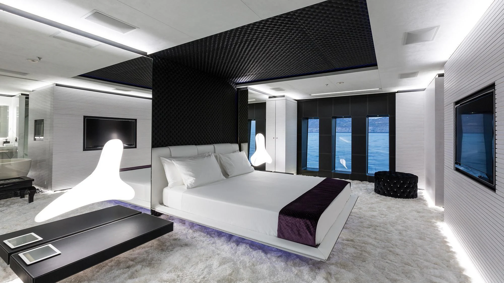 a large room with a bed and a tv aboard OCEAN PARADISE Yacht for Sale