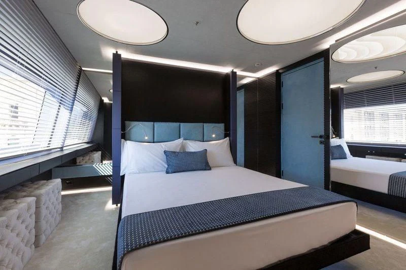 a room with a bed and a window aboard OCEAN PARADISE Yacht for Sale