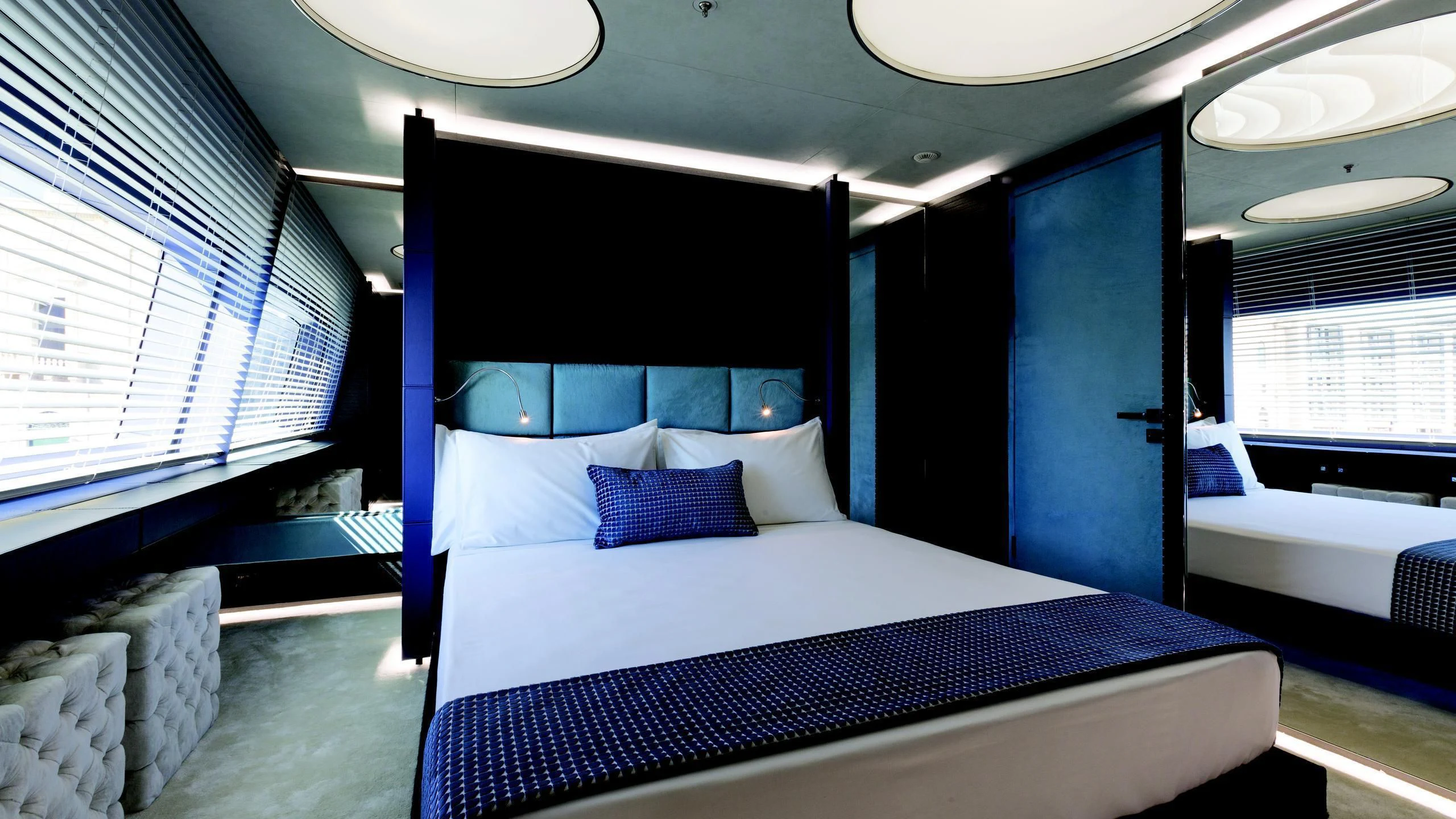 a room with a bed and a blue bed aboard OCEAN PARADISE Yacht for Sale