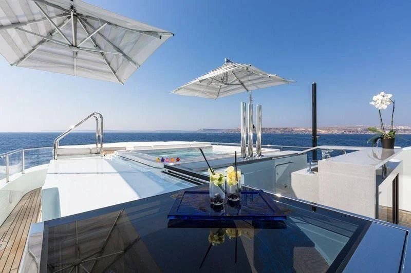 a pool with umbrellas and flowers aboard OCEAN PARADISE Yacht for Sale