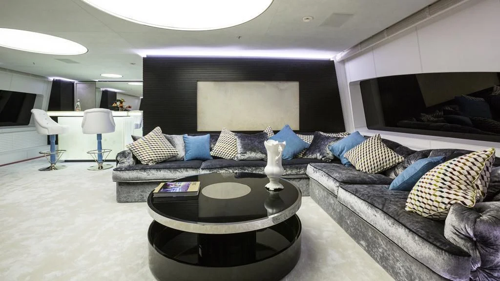 a living room with a couch and a coffee table aboard OCEAN PARADISE Yacht for Sale