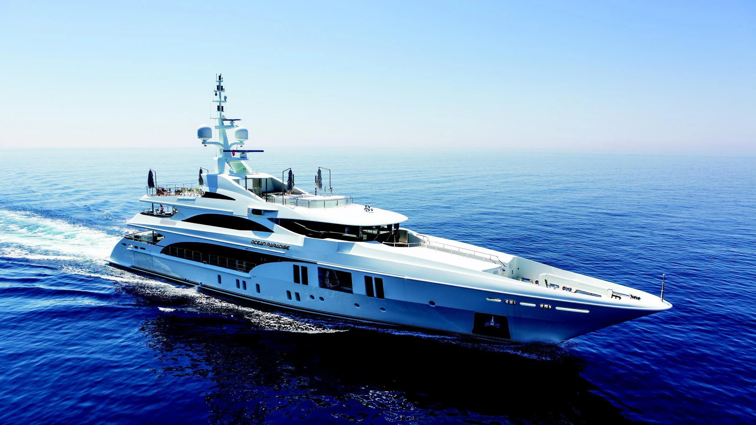 a large white boat in the water aboard OCEAN PARADISE Yacht for Sale