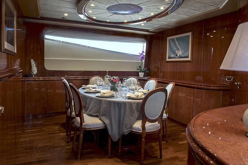 a dining room with a table set aboard SUGAR Yacht for Sale