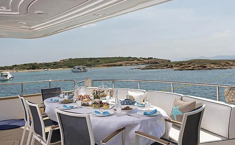 a table set for a meal on a boat aboard SUGAR Yacht for Sale