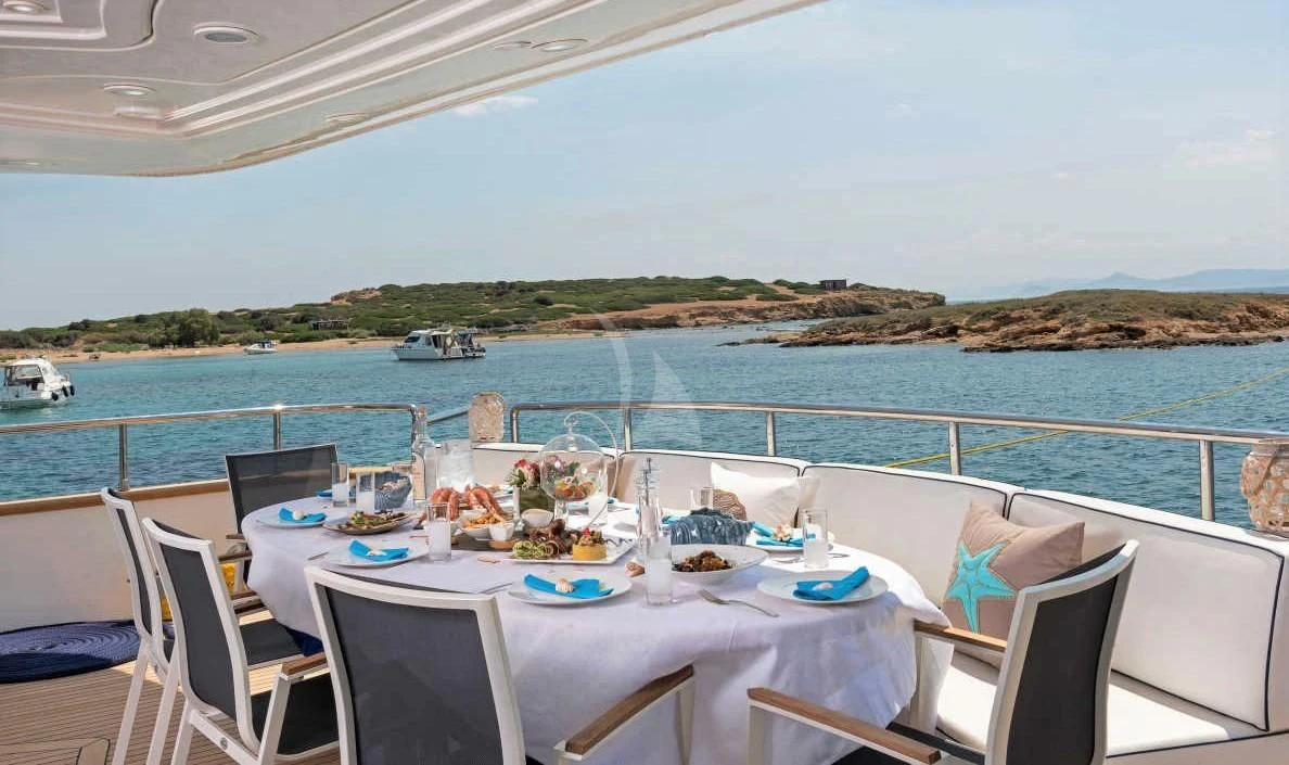 a table set for a meal on a boat aboard SUGAR Yacht for Sale