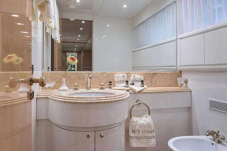 a bathroom with a sink and a mirror aboard SUGAR Yacht for Sale