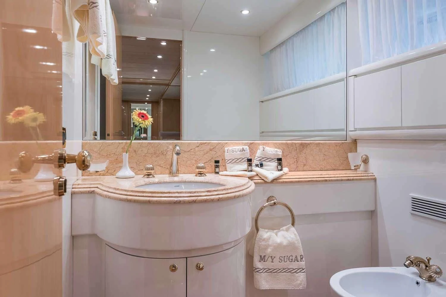 a bathroom with a sink and a mirror aboard SUGAR Yacht for Sale