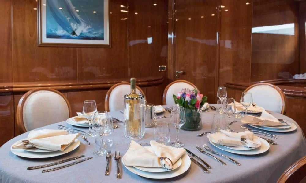 a table set with place settings aboard SUGAR Yacht for Sale