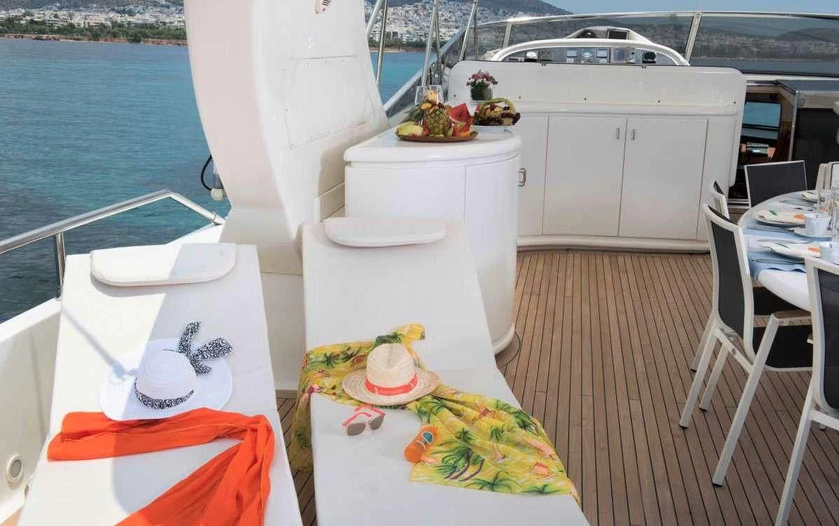 a boat with a table and chairs on the deck aboard SUGAR Yacht for Sale