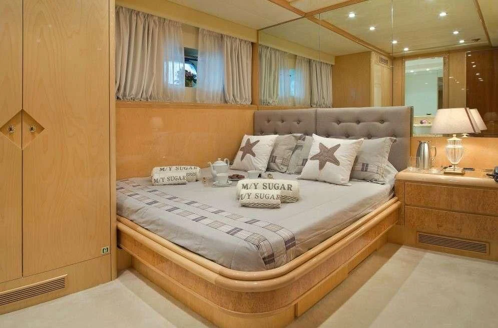 a bed with white sheets aboard SUGAR Yacht for Sale